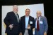 Professor T. Grandon Gill, Chair of the Award Ceremony, and Dr. Nagib Callaos, General Chair, giving Mr. Joseph Prezzama, a plaque "In Appreciation for A Great Keynote Address at a Plenary Session."